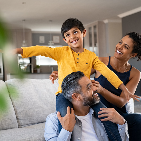 Happy son playing with ethnic parents