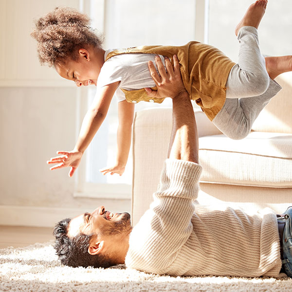 Father lifting daughter in the air