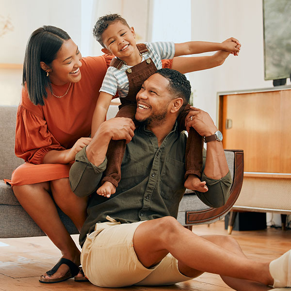 Happy mixed-race family of three relaxing in the living room