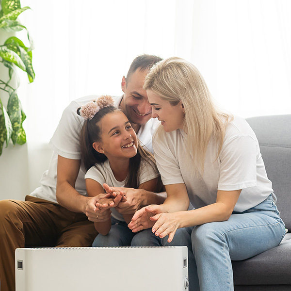 Family warming hands near a heater