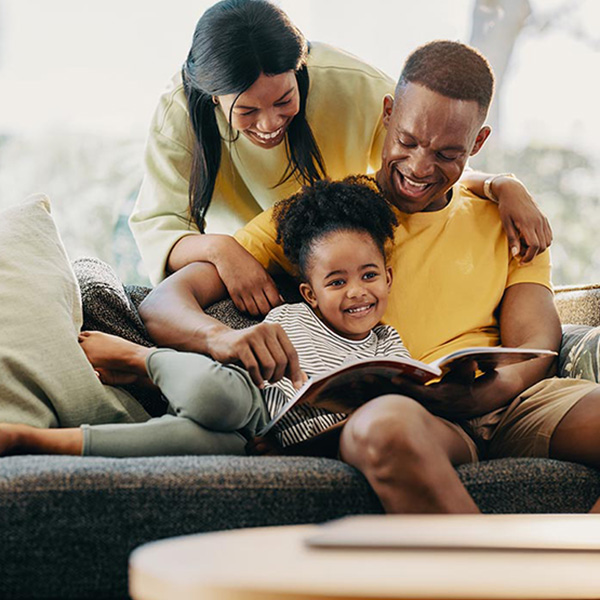 Happy family ready book in living room