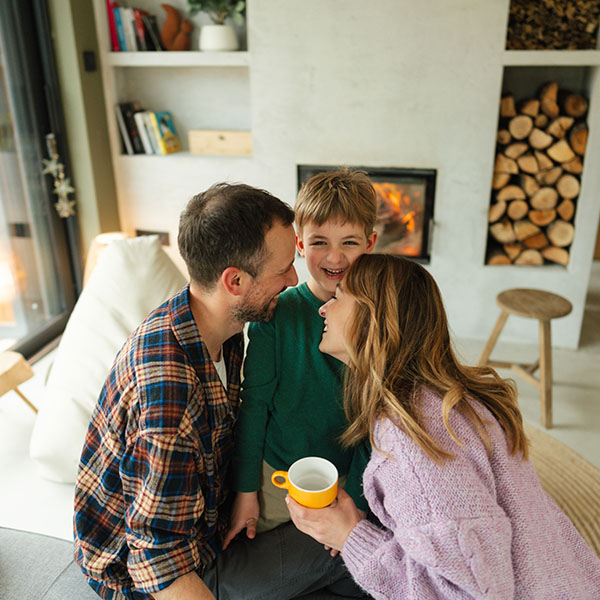 Beautiful family with a young boy, spending quality time together in their living room