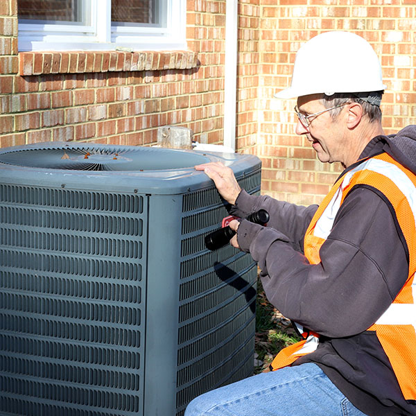 Technician inspecting HVAC unit