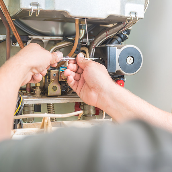 Technician repairing gas furnace