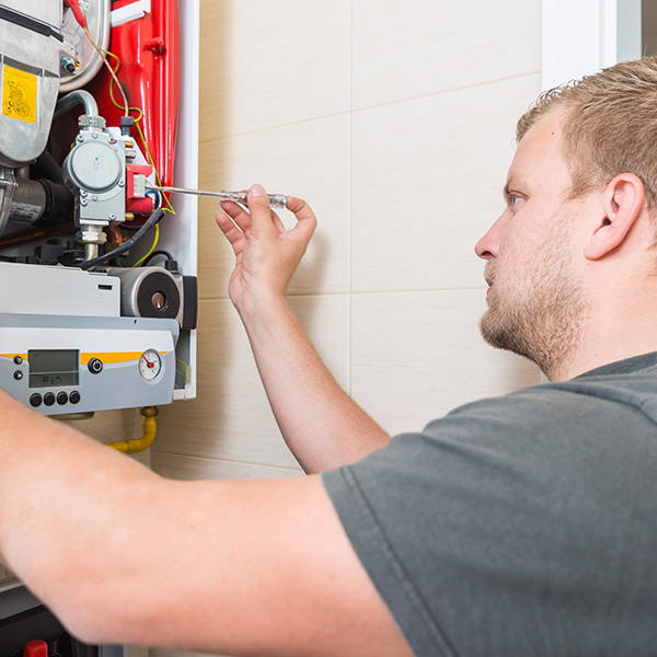 Technician repairing gas furnace