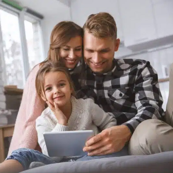 Happy family in living room looking at tablet