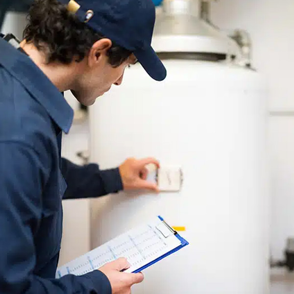Technician fixing water heater inside house