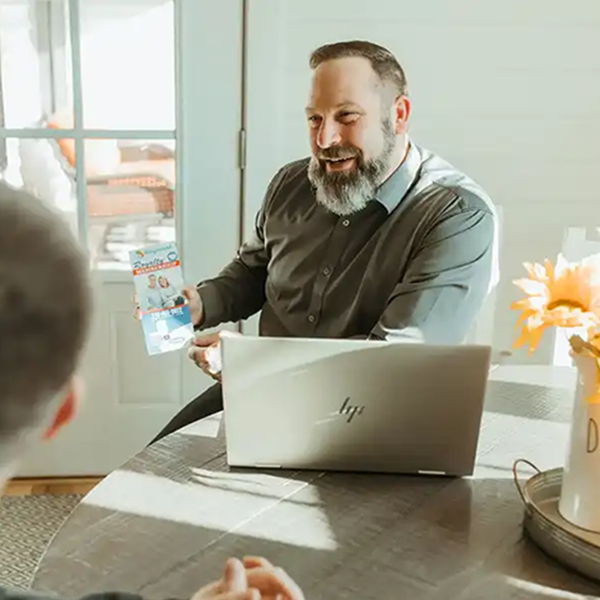 Happy man showing flyer to client